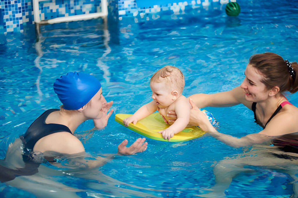 Swimming instructor guiding a baby during a pool session