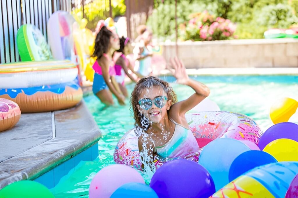 Kids playing with colorful balloons during a pool party
